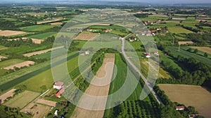 Panoramic aerial top drone view of modern speed highway. Picturesque road among the green fields.