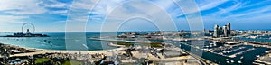 Panoramic aerial view around Jumeirah Beach with Ain Dubai, Skydive Dubai, Dubai Harbour, The Palm, JBR Beach and Bluewater island