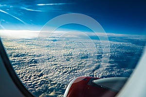 Panoramic aerial view. Beautiful sunset sky above clouds with dramatic light. Cabin view from airplane. Passenger airliner.