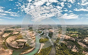 Panoramic aerial view of the city of Neuquen. To the left Limay river and to the right Neuquen river. The rivers begin to mix and