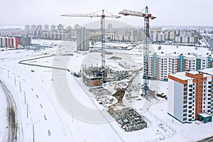 Panoramic aerial view of construction site in winter. new residential area under construction