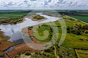 Panoramic aerial view of the countryside with a pond and agricultural fields