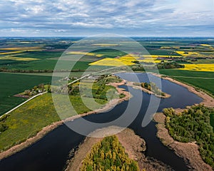 Panoramic aerial view of the countryside with a pond and agricultural fields