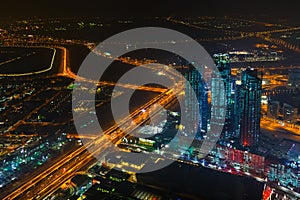 Panoramic aerial view on downtown of Dubai, UAE with modern high skyscrapers at night. Architecture of future with bright lights