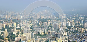 Panoramic aerial view of foggy, polluted, crowded extended suburbs of Navi Mumbai New Bombay