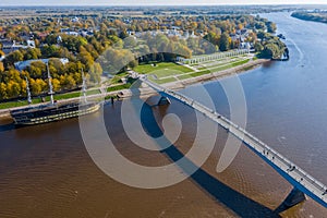 Panoramic aerial view of the Great Bridge and the Volkhov River in Veliky Novgorod, autumn trees on a sunny day. Frigate Flagship