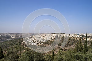 Panoramic aerial view on highway among the hills of Jerusalem, Israel. Modern houses of Jerusalem on a slope on the outskirts of