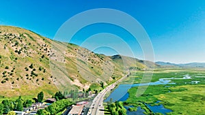 Panoramic aerial view of Jackson Hole homes and beautiful mountains on a summer morning, Wyoming