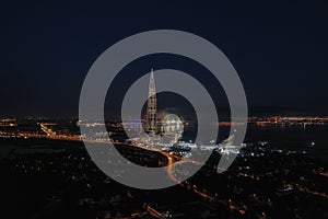 Panoramic aerial view of Lakhta center, festive fireworks, night city