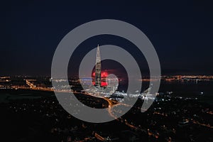 Panoramic aerial view of Lakhta center, festive fireworks, night city