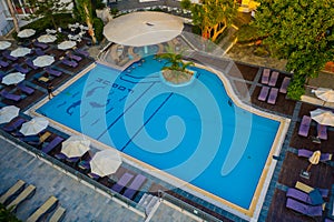 Panoramic aerial view of large swimming pool with bar at luxury tropical hotel apartment resort. Rhodes, Greece, Europe