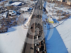 Panoramic aerial view on the Leningradsky Highway on a cold sunny day in winter. Beautiful urban landscape river covered with ice