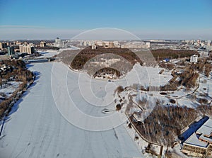 Panoramic aerial view on the Leningradsky Highway on a cold sunny day in winter. Beautiful urban landscape river covered with ice