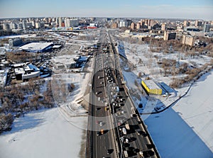 Panoramic aerial view on the Leningradsky Highway on a cold sunny day in winter. Beautiful urban landscape river covered with ice