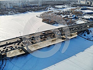 Panoramic aerial view on the Leningradsky Highway on a cold sunny day in winter. Beautiful urban landscape river covered with ice