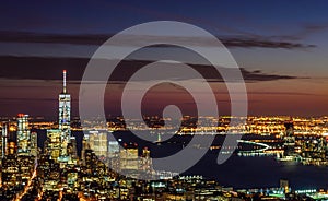 Panoramic and Aerial View of Manhattan, New York City at Night. Illuminated Buildings After Sunset. Beautiful Crimson Colors in th