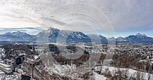 Panoramic aerial view of Mochsberg top with view of Untersberg snow mountain in Salzburg winter