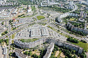 Panoramic aerial view of modern residential neighborhood, road intersection, shopping malls and parking lots photo