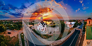 Panoramic aerial view of old church near river and bridge in small european city