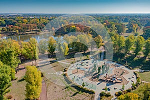 Panoramic aerial view over a modern and complex children playground at the city park Rotehorn in Magdeburg, Germany, at blue sky