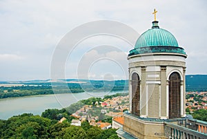 Panoramic aerial view over the roofs of Esztergom town near Budapest, Danube river and a tower of Esztergom Cathedral at the fore