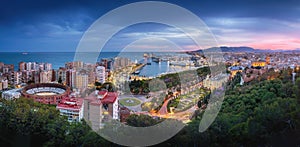 Panoramic aerial view with Plaza de Toros, Port of Malaga, City Hall and Cathedral at sunset - Malaga, Andalusia, Spain