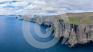 Panoramic aerial view from Sandoy island cliffs under the clouds photo