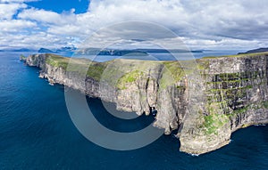 Panoramic aerial view from Sandoy island cliffs under the clouds photo