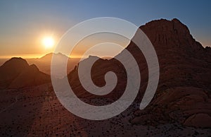 Panoramic, aerial view on a silhouette of a ancient Spitzkoppe mountain against sunset. Rocky desert landscape. Travelling to