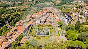 Panoramic aerial view of a small Italian town with square park, railway and bridge