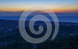 Panoramic aerial view on valley and town, plantations and villages on Rhodes island at deep night. Scenic landscape. Dodecanese,