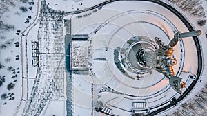 Panoramic aerial view of winter city Kyiv covered in snow. The Motherland Monument