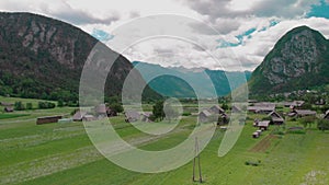 Panoramic aerial view of wooden house and barn at mountains