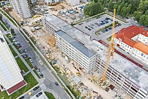 Aerial view of working crane at construction site. multistory parking garage under construction