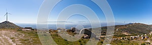 Panoramic and amazing view from the top of the Caramulo mountains over the Serra da Estrela mountains, wind turbines and granitic