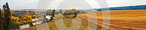 Panoramic autumn countryside landscape with field and road