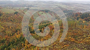 Panoramic autumn view of road, hills and fields near