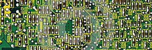 Panoramic banner Green printed circuit board PCB with chip texture or background. Electronic embedded system design. Minimal