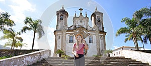 Panoramic banner view of beautiful tourist woman visiting the baroque colonial city of Ouro Preto, old capital of the state of