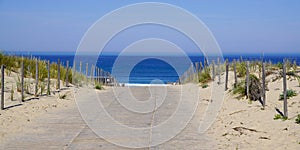 Panoramic beach sea with sand dunes and sandy wooden floor fence access on atlantic ocean in gironde France southwest