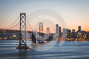 Panoramic beautiful scenic view of the Oakland Bay Bridge and the SF city at dusk, San Francisco, California