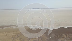 Panoramic beautiful top viewview from above of the Maranjob desert. The drone moves slowly along dried-up salt Lake Namak.