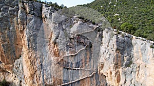 Panoramic beautiful vertiginous impressive aerial view from bottom to top of wooden staircase at rock cliff as part of