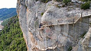 Panoramic beautiful vertiginous impressive aerial view from bottom to top of wooden staircase at rock cliff as part of