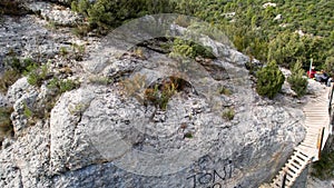 Panoramic beautiful vertiginous impressive aerial view from bottom to top of wooden staircase at rock cliff as part of