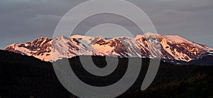 Panoramic beautiful view of evening lights on the snowy mountain peaks