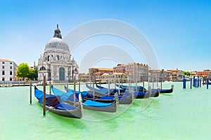 Panoramic beautiful  view of traditional venetian gondolas moored in water of Grand Canal in front of Basilica di Santa Maria