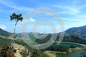 Panoramic Beauty From Panca Warna Peak: Lake, Mountains, and Distant City