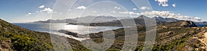 Panoramic of Calvi citadel and mountains from Revellata in Corsica