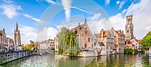 Panoramic city view Belfry tower and famous canal in Bruges, Belgium. photo